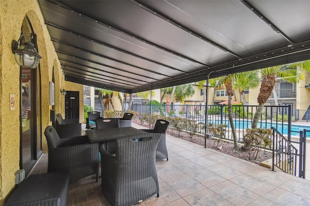 view of patio featuring fence and a community pool