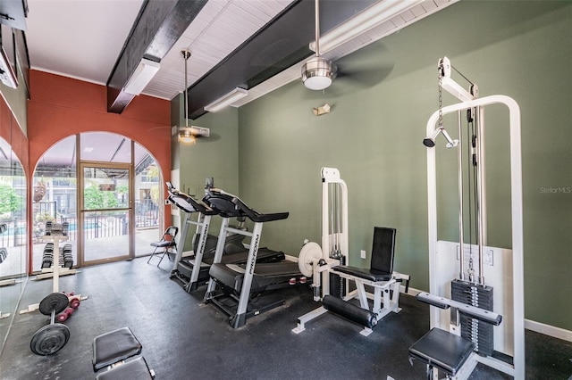 exercise room featuring a ceiling fan and baseboards