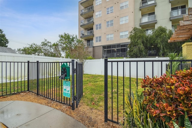 view of home's community featuring fence and a lawn