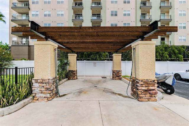 view of parking / parking lot featuring fence