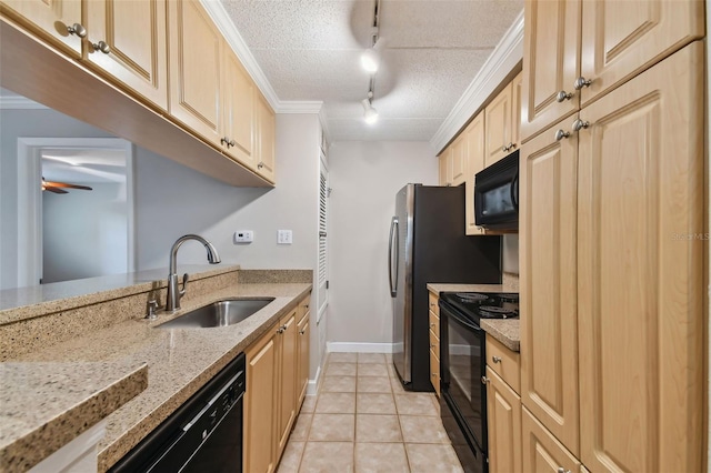 kitchen featuring a textured ceiling, light tile patterned floors, a sink, light stone countertops, and black appliances