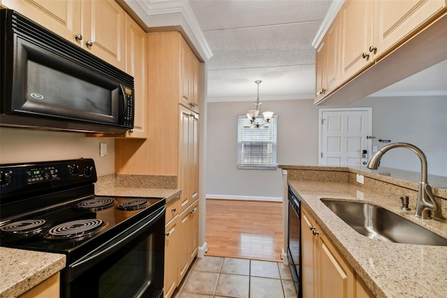 kitchen with decorative light fixtures, crown molding, black appliances, light brown cabinets, and a sink