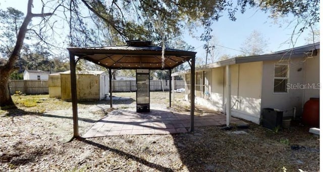 view of patio / terrace with a gazebo and a shed