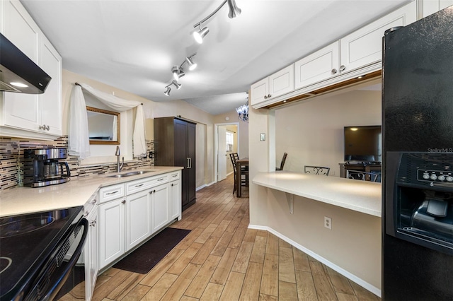 kitchen featuring light hardwood / wood-style floors, white cabinetry, and sink