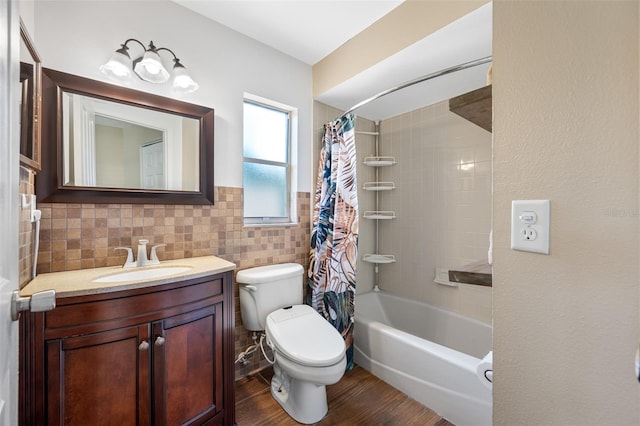 full bathroom with shower / bath combo, toilet, vanity, tile walls, and hardwood / wood-style flooring