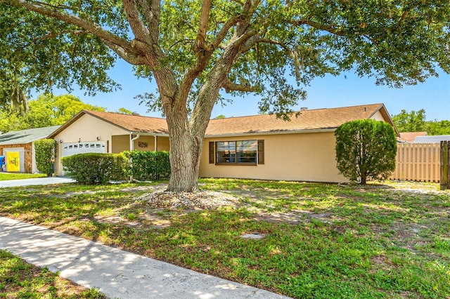 ranch-style house featuring a front lawn and a garage