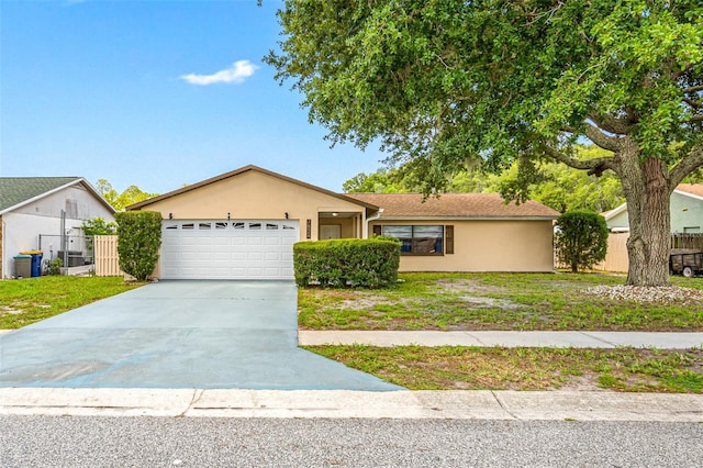 single story home with a garage and a front lawn