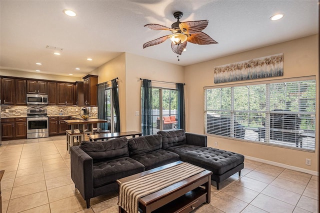 tiled living room featuring ceiling fan