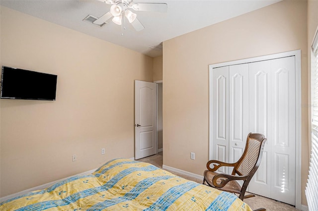 bedroom featuring light carpet, a closet, and ceiling fan