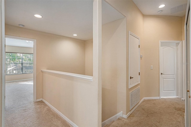 hallway with light colored carpet