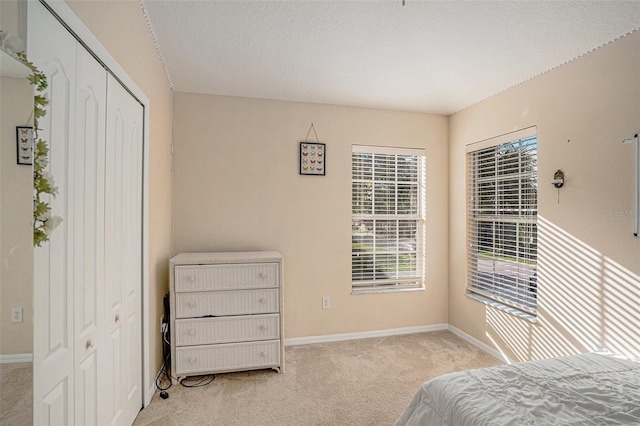 carpeted bedroom with a closet