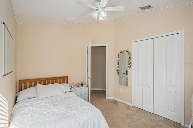 bedroom featuring ceiling fan, light colored carpet, and a closet