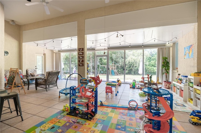 playroom featuring ceiling fan and light tile patterned flooring