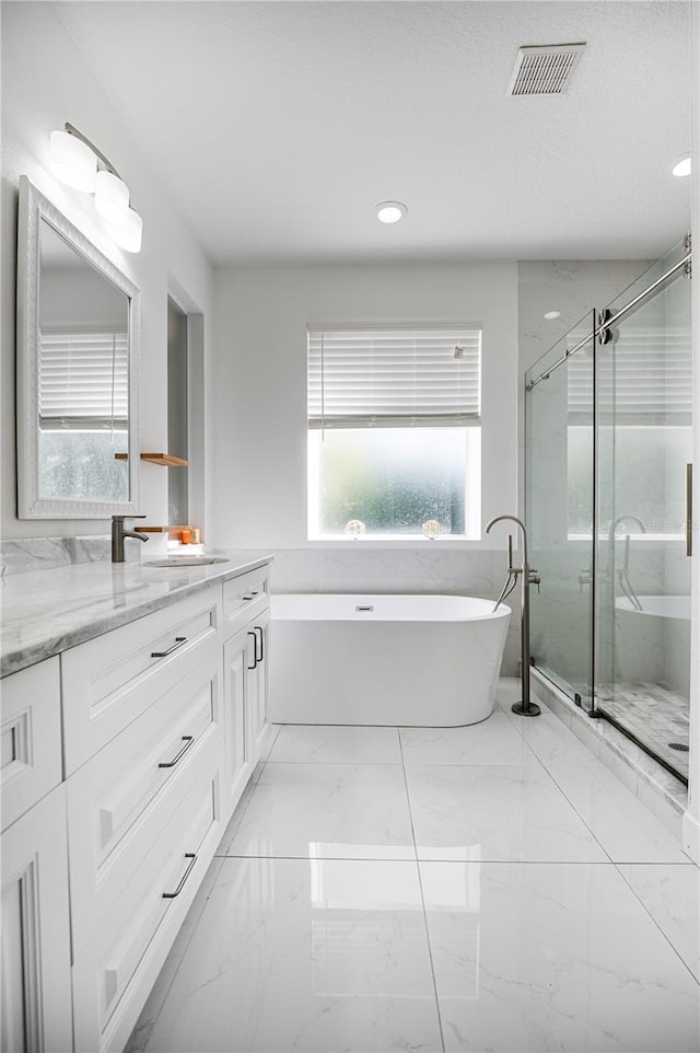 bathroom with shower with separate bathtub, tile patterned floors, and vanity