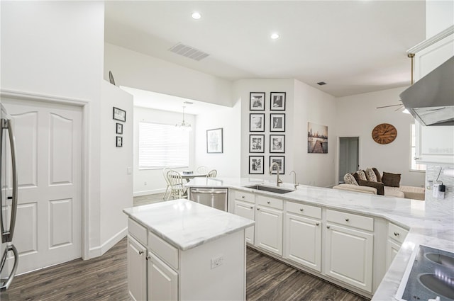 kitchen featuring stainless steel dishwasher, white cabinets, dark hardwood / wood-style flooring, and sink