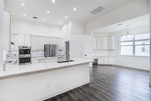 kitchen featuring dark wood-type flooring, stainless steel appliances, sink, and white cabinetry