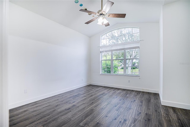 spare room with a ceiling fan, dark wood-style floors, lofted ceiling, and baseboards