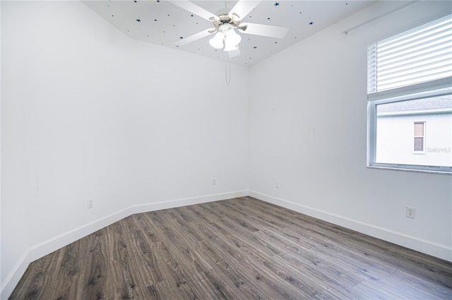 spare room with ceiling fan, hardwood / wood-style flooring, and a wealth of natural light