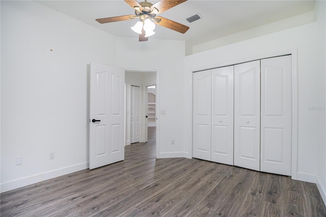 unfurnished bedroom with ceiling fan, hardwood / wood-style flooring, and a closet