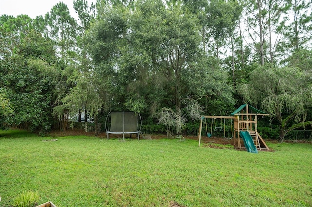 view of yard featuring a playground and a trampoline