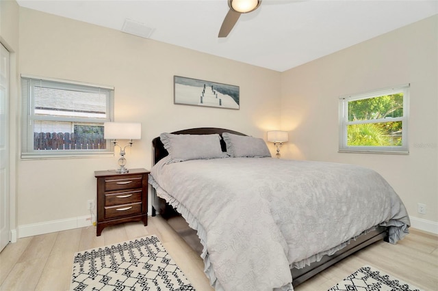 bedroom with ceiling fan and light wood-type flooring