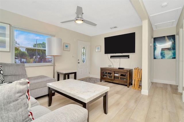 living room with light hardwood / wood-style floors and ceiling fan