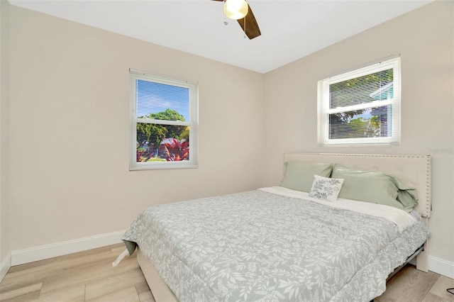 bedroom with light wood-type flooring and ceiling fan