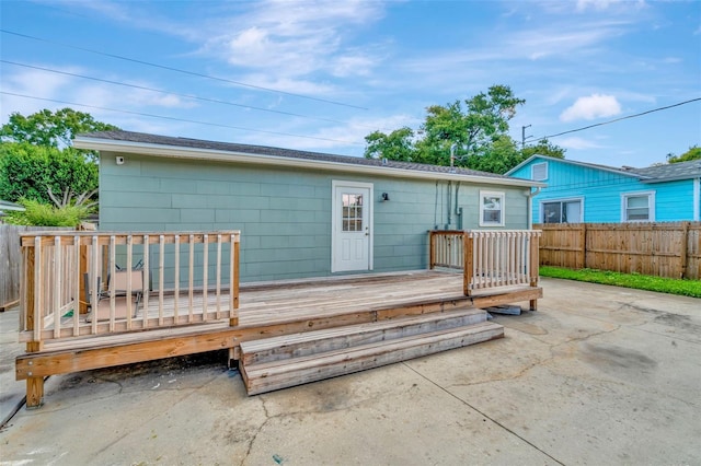 rear view of house featuring a patio and a wooden deck