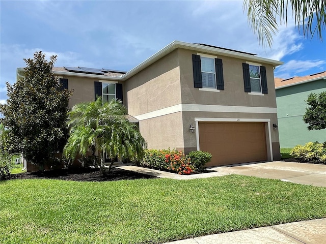 view of front facade featuring solar panels, a garage, and a front yard