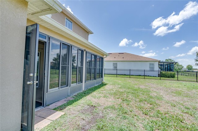 view of yard featuring a sunroom