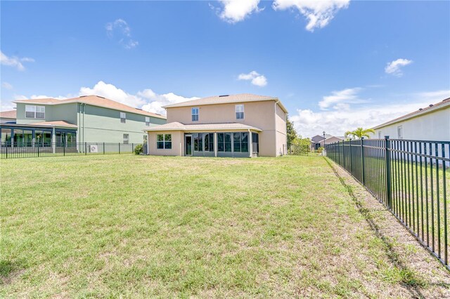 back of house featuring a yard