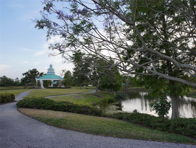 view of property's community featuring a gazebo, a yard, and a water view