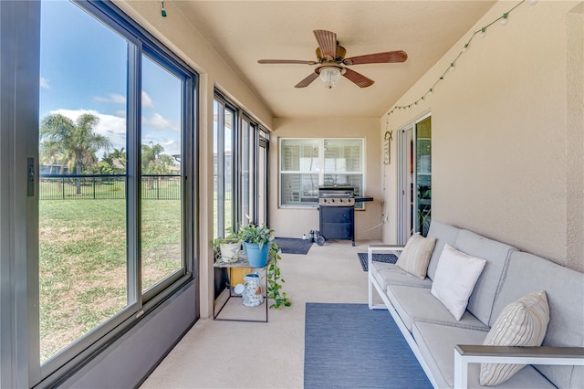 sunroom / solarium featuring carpet