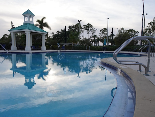 community pool with a gazebo