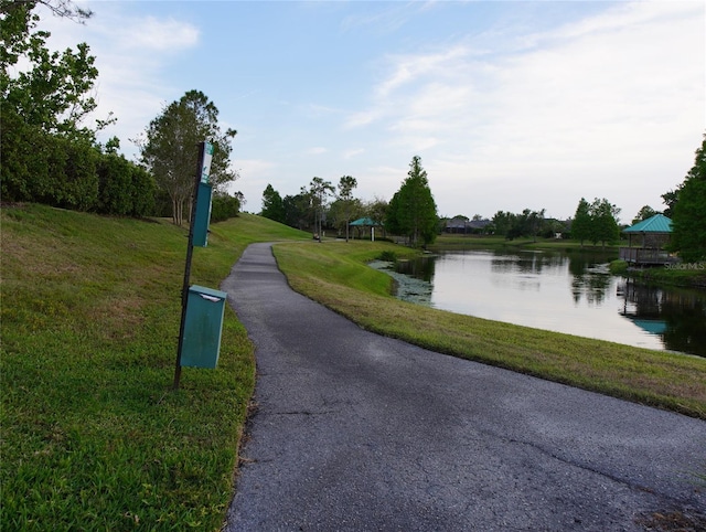 view of community featuring a gazebo, a lawn, and a water view