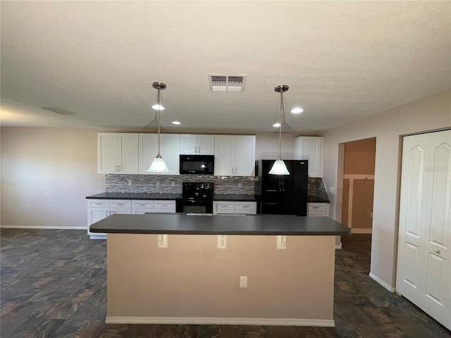 kitchen featuring black appliances, dark countertops, decorative backsplash, and visible vents