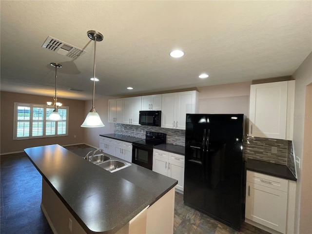 kitchen featuring a sink, black appliances, dark countertops, and visible vents