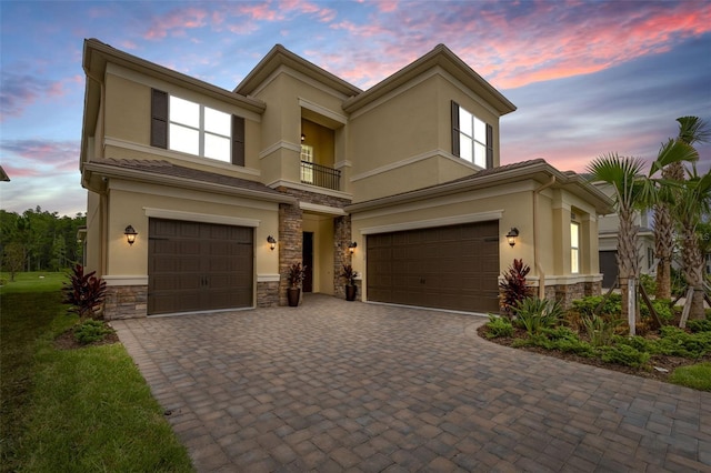 view of front of house featuring a garage and a balcony