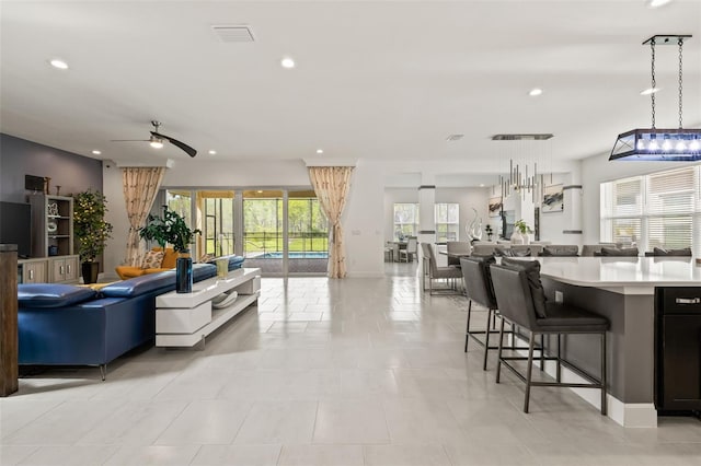 tiled living room featuring ceiling fan