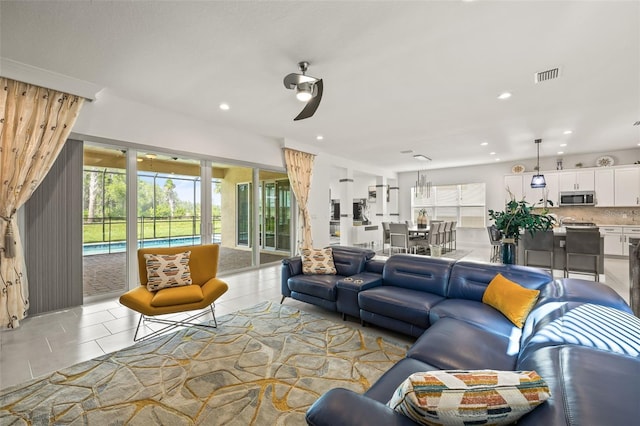 tiled living room featuring ceiling fan