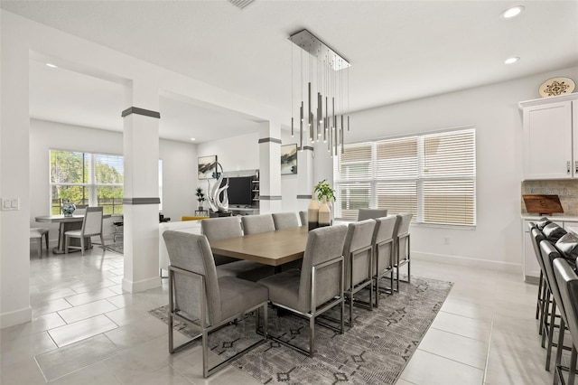 dining area featuring light tile patterned floors and an inviting chandelier