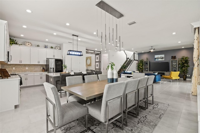 tiled dining area with ceiling fan