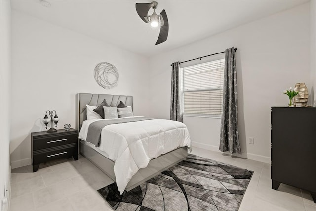 bedroom with ceiling fan and light tile patterned flooring