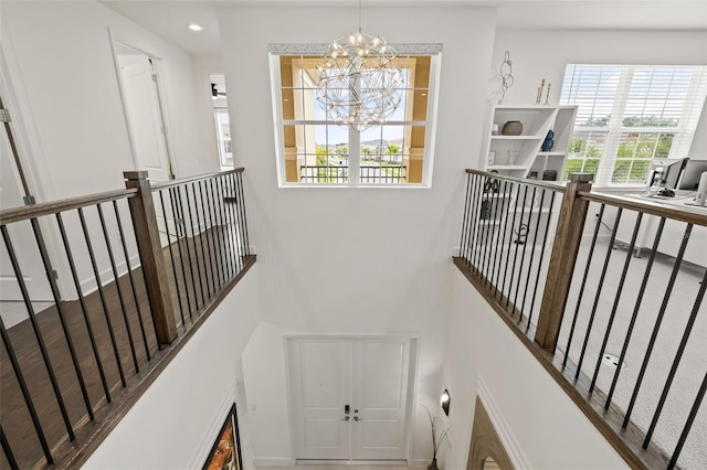 stairs with an inviting chandelier