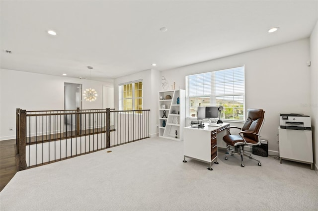 home office featuring a notable chandelier and light carpet