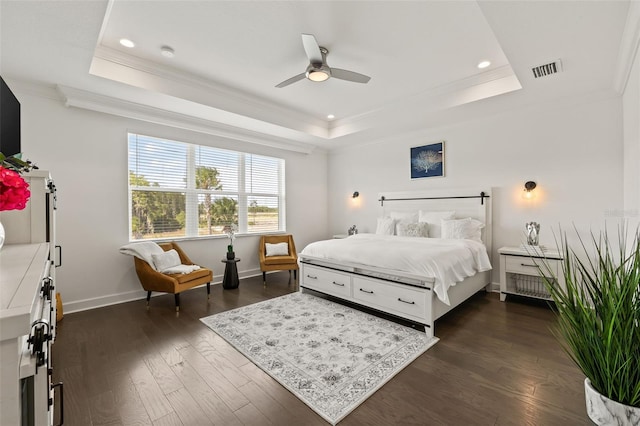 bedroom with a raised ceiling, ceiling fan, and dark hardwood / wood-style floors