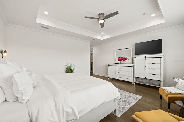 bedroom with ceiling fan, ornamental molding, and a tray ceiling