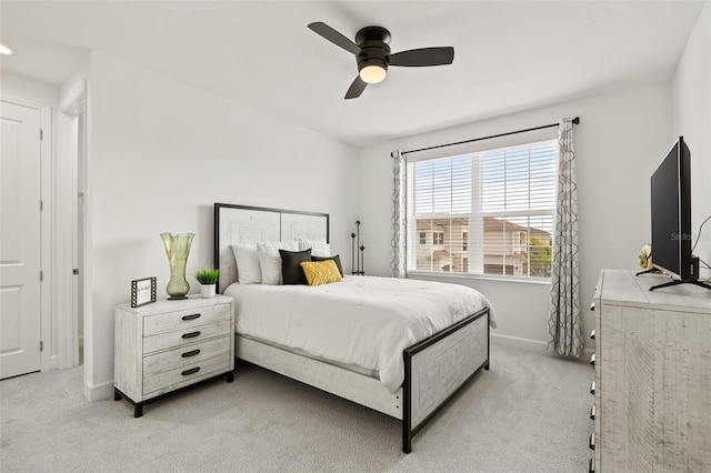 bedroom with ceiling fan and light carpet