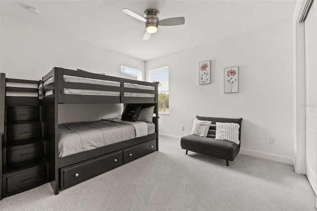 bedroom featuring light carpet, a closet, and ceiling fan