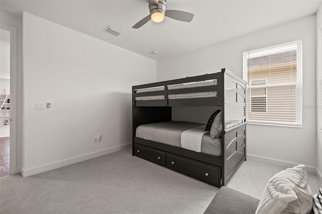 bedroom with ceiling fan and light colored carpet